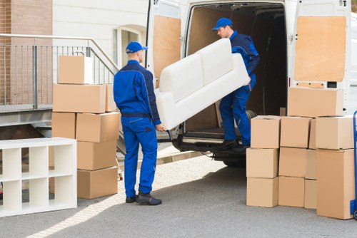 Removal workers securing items safely inside a moving vehicle