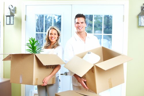 Packed boxes and furniture ready for transport with a removal van